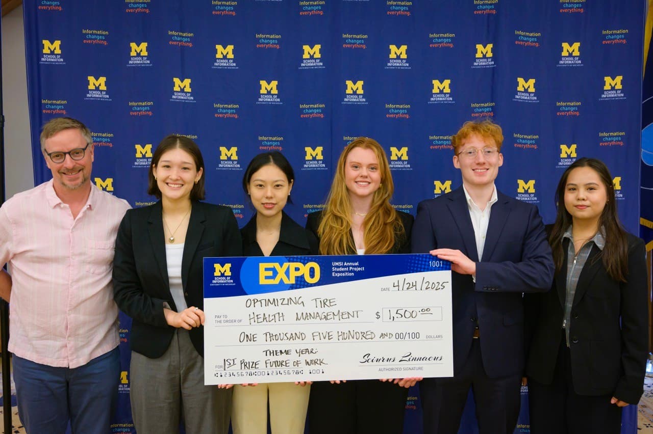 Team holding the 2025 UMSI Expo first prize check